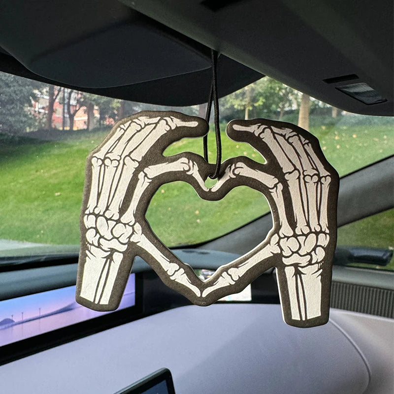 Two skeleton hands forming a heart shape in bold black and white Hilton Hanging Car Air Freshener