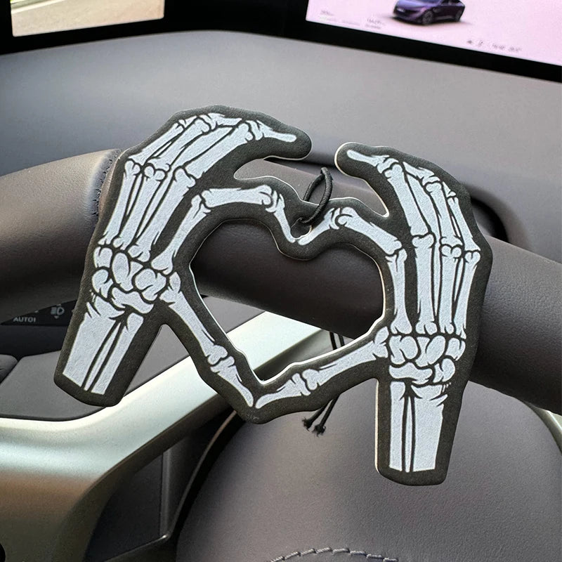 Two skeleton hands forming a heart shape in bold black and white Hilton Hanging Car Air Freshener
