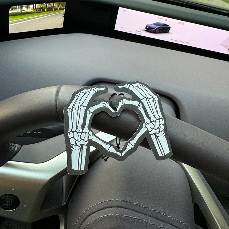 Two skeleton hands forming a heart shape in bold black and white Hilton Hanging Car Air Freshener